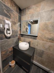a bathroom with a sink and a mirror at Les Mélèzes in Saint-Chaffrey +7 photos