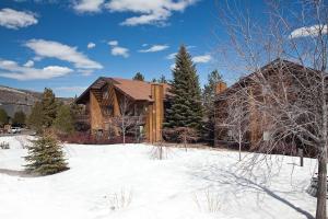 a house in the snow with trees in front of it at Red Pine Hideaway in Park City