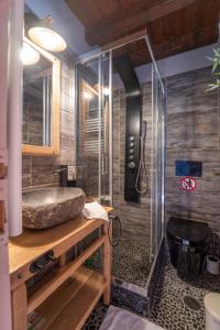 a bathroom with a sink and a glass shower at Rock Dandy Deluxe Chalet in Arachova - Delphi, Sauna, Prv Parking, Amazing View in Arachova