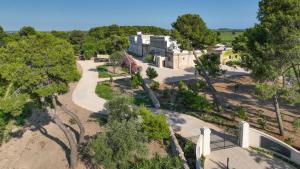 an overhead view of a park with trees and a building at Masseria Tenute Emera By Raro Villas in Lizzano