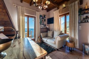 a living room with a couch and a table at Rock Dandy Deluxe Chalet in Arachova - Delphi, Sauna, Prv Parking, Amazing View in Arachova