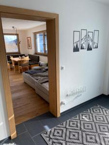 a room with a bed and a dining room at Ferienwohnung Fotscherblick in Sellrain