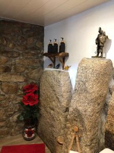 a room with two large rocks and a stone wall at Casas do Lobo in Tarouca