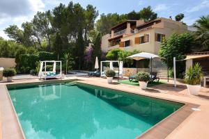a swimming pool in front of a house at Delightful Ibiza Villa - Spectacular Mountain Views - Villa Jasmine - 4 Bedrooms - Ibiza Town in Sant Rafael de Sa Creu