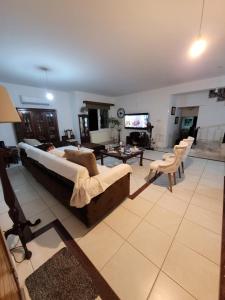 a large living room with a large bed and a tv at Beautiful bedroom in Limassol