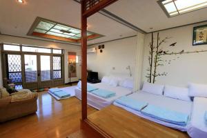 a living room with two beds and a couch at Gods Home in Checheng