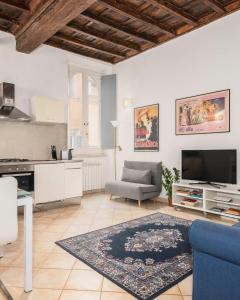 a large living room with a couch and a tv at Suites Campo de' Fiori - Zen Real Estate in Rome
