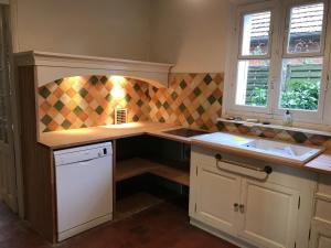 a kitchen with a sink and a counter top at Grand Clos Normand in Varengeville-sur-Mer +25 photos