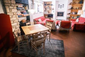 a living room with a table and chairs at Chalet Maso Pino in Castello Tesino