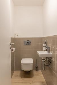 a bathroom with a toilet and a sink at NFS - Národný futbalový štadión - Apartman in Bratislava