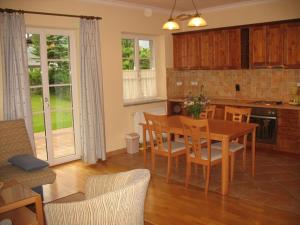 a kitchen and dining room with a table and chairs at Apartments Timjana in Bohinj