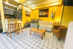 a living room with a couch and a table at #M1 La maisonnette des 3 ponts Terrace in Saint-Égrève