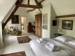 a bedroom with a large white bed in a room at Clos Normand in Varengeville-sur-Mer