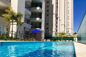 a large swimming pool in front of a building at 0408 - Studio Essenza Maia - Conforto Refinado in Guarulhos +13 photos