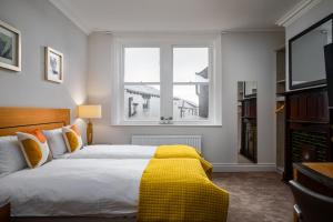 a bedroom with a large bed and a window at Elephant and Castle in Wakefield