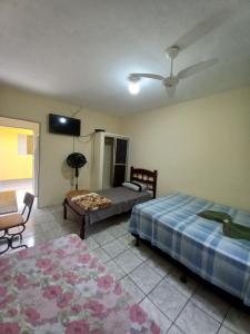 a bedroom with two beds and a flat screen tv at Hotel em SBO - Centro in Santa Bárbara dʼOeste