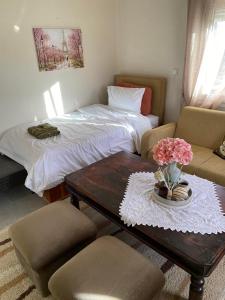 a living room with a bed and a table and chairs at Traditional villa KALAMPAKA 