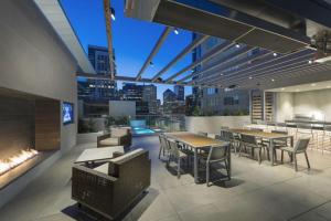 a rooftop patio with tables and chairs and a fireplace at Rincon Hill 1BR w WD Gym Pool nr Tech HQs SFO-778 in San Francisco