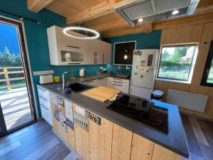 a kitchen with a sink and a refrigerator at Le Chal'étincelle in Valdeblore