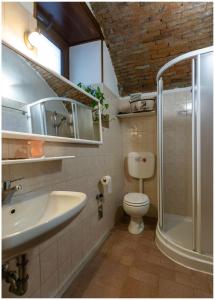 a bathroom with a sink and a toilet and a shower at Casa Vacanza Scacco d' Argento in Boario Terme