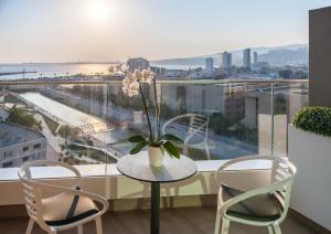 a table with a vase of flowers on a balcony at Four Points by Sheraton Izmir in Izmir