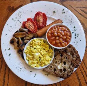a plate of breakfast food with eggs beans and toast at Ambleside Manor - Vegetarian B&B in Ambleside +19 photos