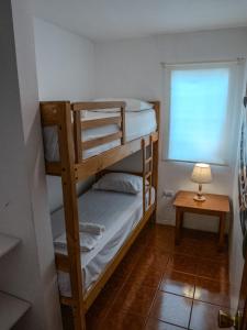 a bedroom with two bunk beds and a lamp at Las Casitas en Salinas in Salinas