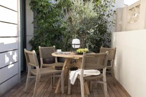 a wooden table and chairs on a patio at The Onsider - Penthouse 3 Bedroom Apartment - Paseo de Gracia in Barcelona