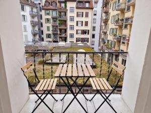 a balcony with two wooden benches and buildings at Easy-Living Lucerne City Apartments 1 in Lucerne