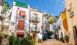 a group of buildings with stairs in a town at Geomar Penthouse in Alicante