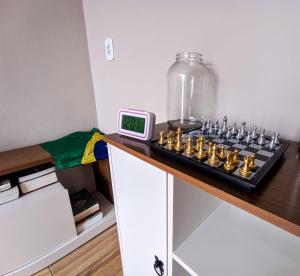 a clock sitting on a counter next to a chessboard at Pousada do Nestor in São Gabriel