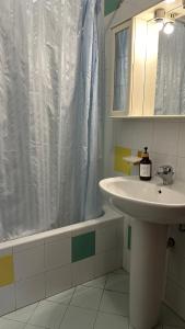 a bathroom with a sink and a shower curtain at Appartamento Vittoria in Vittoria