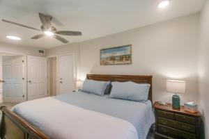a bedroom with a bed and a ceiling fan at Bright Jekyll Island Home with Deck Less Than 1 Mi to Beach in Jekyll Island