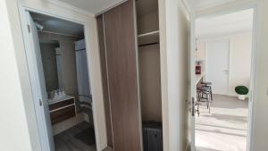 a door leading into a bathroom with a sink at Departamento con espectacular vista al mar Arica, Condominio Ayllu in Arica +26 photos
