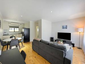 a living room with a couch and a table at 'The Grange' Coastal Charm near Henley Beach in Adelaide
