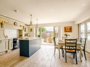 a kitchen with a table and a dining room at 3 bed in Ilminster 77987 in Cudworth