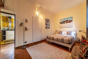 a bedroom with a bed and a living room at Piazza Navona Penthouse in Rome