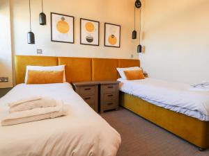 a room with two beds and a mirror at Malham in Skipton +25 photos
