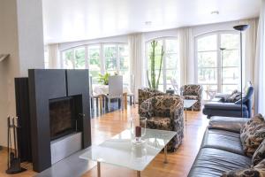 a living room with a couch and a fireplace at ArtVilla am See - buchbar April-Mai 2024 in Radolfzell am Bodensee