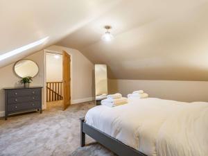 a bedroom with a large white bed and a mirror at 5 bed in Lytham 85675 in Weeton