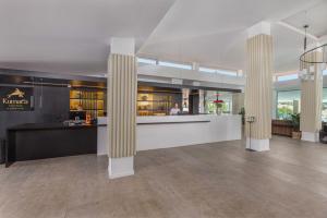 un vestíbulo con columnas y un bar en un edificio en Kumara Serenoa By Lopesan Hotels en Maspalomas