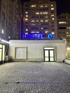 a building with a hospital sign on it at night at Hostel O2 in Almaty