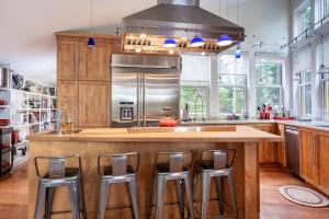 a kitchen with a large island with bar stools at Lodging at Goose Cove Retreat - Trinity, Newfoundland in Trinity