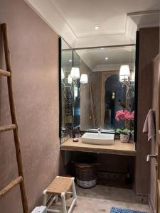 a bathroom with a sink and a mirror at Villa Marrakech piscine privée vue sur Golf&Atlas in Marrakech