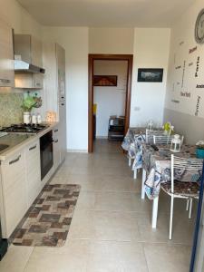 a kitchen with a row of tables in a room at A Casa di Fabio Holiday House in Bari