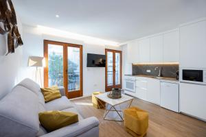 un salon avec un canapé et une cuisine dans l'établissement San Jerónimo Catedral 2BR, à Grenade