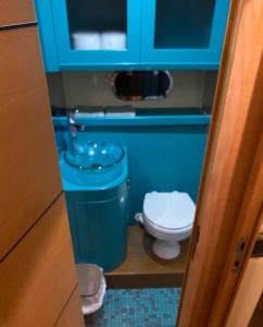 a small bathroom with a toilet and a blue cabinet at Miamoryacht in Nydri
