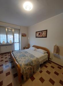 a bedroom with a large bed in a room at AGLIANO LOVELY APARTMENT in Agliano Terme