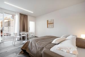 Tempat tidur dalam kamar di Palazzo Ruzante Padova - Atene Apt