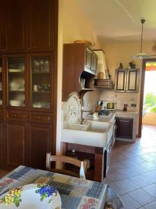 a kitchen with a sink and a counter top at Villetta tre delfini in Custonaci